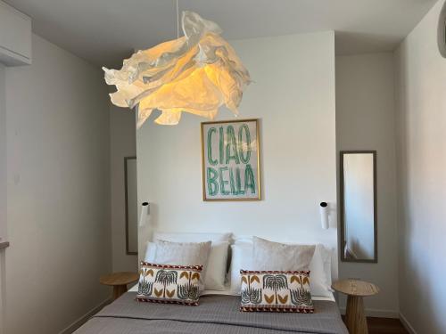a bedroom with a bed with two pillows at Casa MauRo in Senigallia