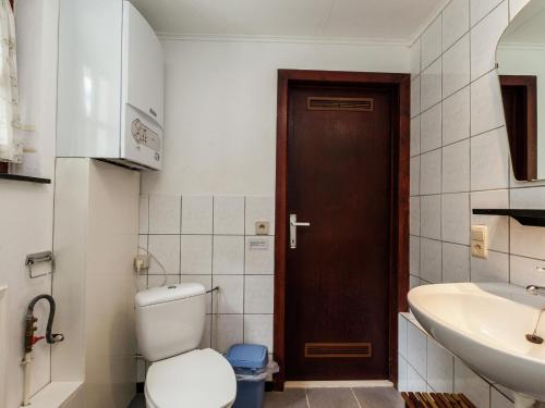 a bathroom with a toilet and a sink at Cottage Near Durbuy Forest in Barvaux