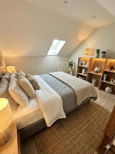 a bedroom with a bed with pillows and a window at Sandstone in Noisy-sur-École