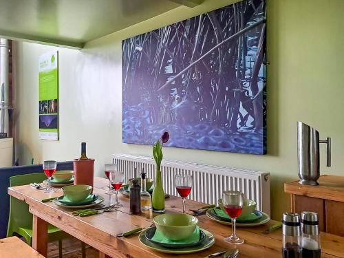 a wooden table with plates and wine glasses on it at Jupiter 1 - Uk50471 in Greenhaugh
