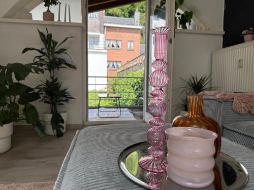 a group of pink glass vases sitting on a table at Chez JAJA in Malmedy