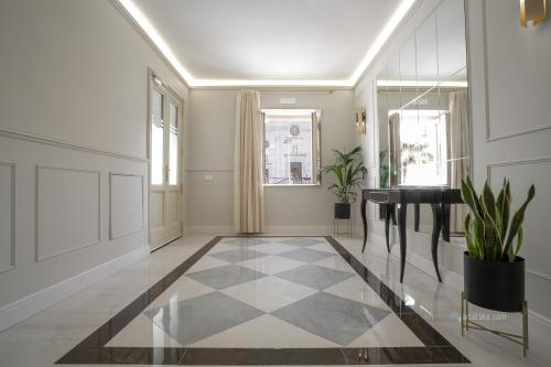 a hallway with a black and white checkered floor at Piazza Duomo Guest House in Ariano Irpino