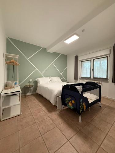 a bedroom with a bed and a tiled floor at Cà par durmì in Gravellona Toce