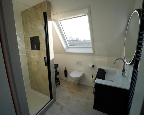 a bathroom with a shower and a sink and a toilet at De Sas in Lisse in Lisse