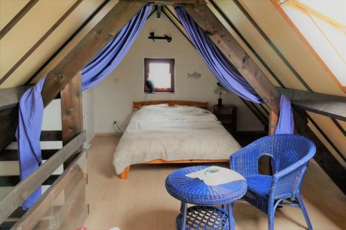 a bedroom with a bed and a table and chairs at Zeewind II 112 in Bredene