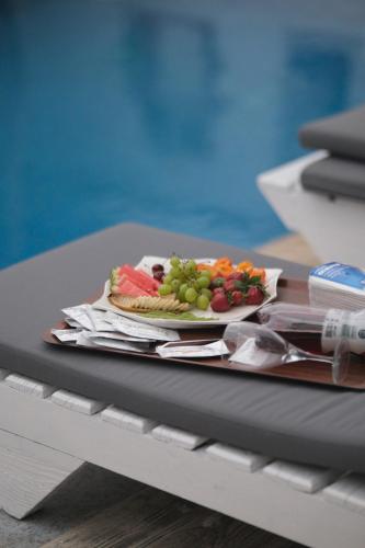 a plate of fruit on top of a table at Alacati Naz Konak in Çeşme