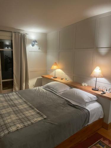 a bedroom with a large bed with two lamps on it at eastwood in San Carlos