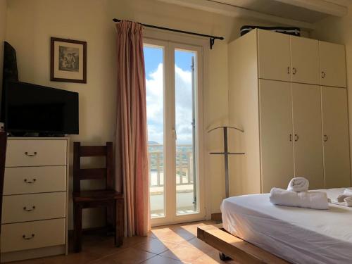 a bedroom with a bed and a sliding glass door at To Diko Mas House in Stení