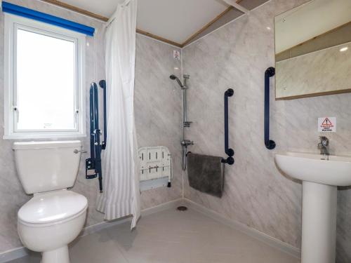 a bathroom with a toilet and a sink at Coastal Escape in Par