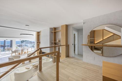 a living room with a staircase and a mirror at Stunning 5-Bed Villa with Private Pool in Manilva