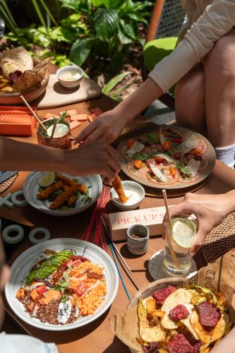 a group of people sitting around a table with plates of food at Kaan Casablanca in Casablanca