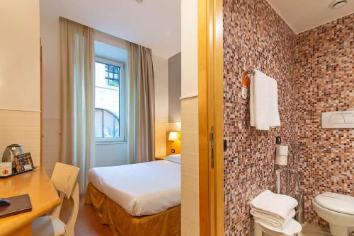 a hotel room with a bed and a bathroom at Hotel Aphrodite in Rome