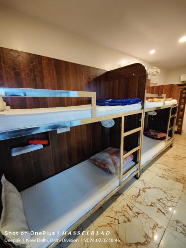 a group of bunk beds in a room at The Charlie Backpackers in New Delhi