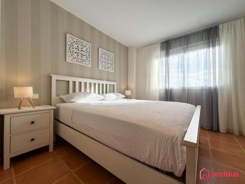 a bedroom with a large bed and a window at El Embarcadero in Oropesa del Mar