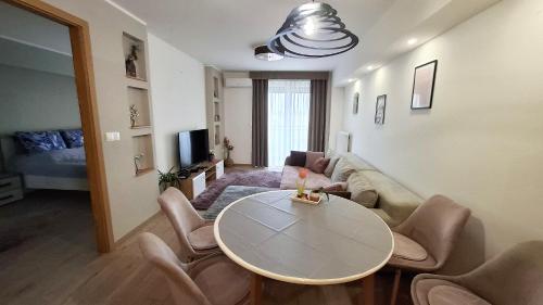 a living room with a table and a couch at Riella Home in Szombathely