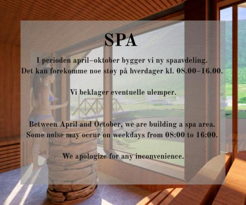 a sign on a glass window with a vase at Vollan Gjestestue in Nordkjosbotn