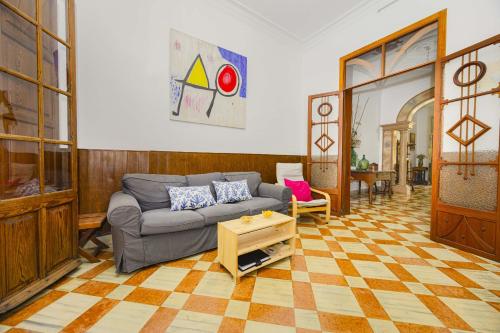 a living room with a couch and a table at Casa de Can Virolla Gran in Sa Pobla