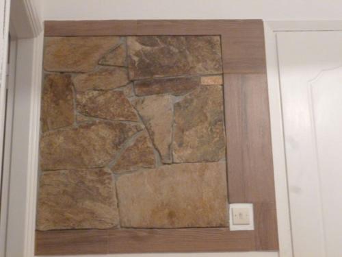 a stone wall in the corner of a bathroom at Vasilis Ios Place II in Ios Chora
