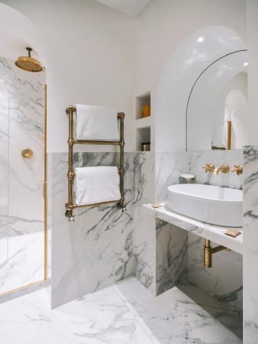 a white bathroom with a sink and a shower at Casa G. Firenze in Florence
