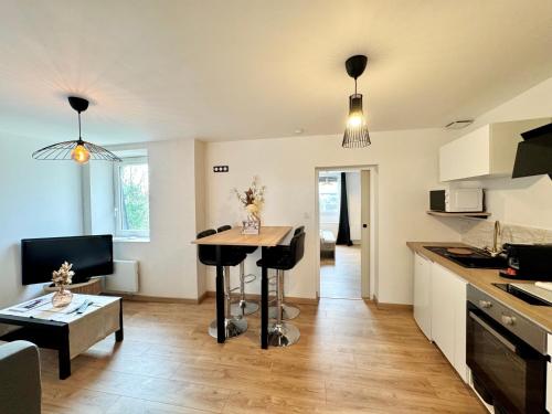 a kitchen with a table in the middle of a room at Chez Jacob, Centre de Rennes in Rennes