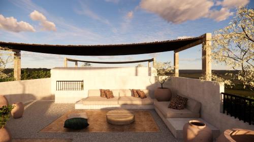 a living room with a couch and a table at Nômade Temple Ibiza - New Opening in Portinatx