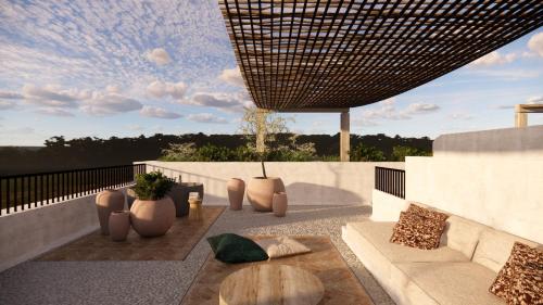 a patio with a table and chairs on a balcony at Nômade Temple Ibiza - New Opening in Portinatx