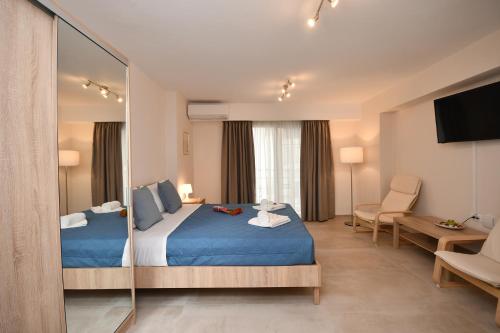 a hotel room with a bed and a mirror at Pietra Sole Residences in Ierapetra