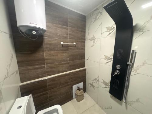 a bathroom with a toilet and a shower at Панорамна гледка in Leshten