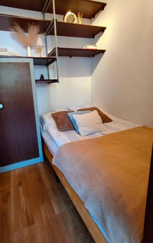 a bedroom with a bed and a wooden floor at Serce Suwałk in Suwałki