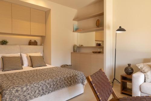 a bedroom with a bed and a table and a chair at Ionian Nest Studio in Pogoniá