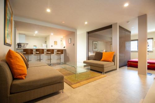 a living room with a couch and chairs and a kitchen at Bito Petrip hotel 美都ペットリップホテル #LP1 in Tuyama