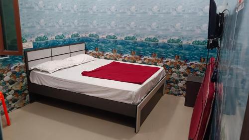 a bedroom with a bed with a view of the water at Rk cottage in Rāmeswaram