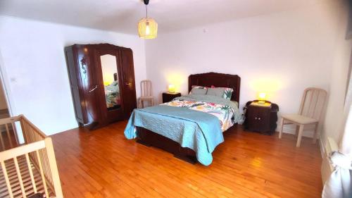 a bedroom with a bed and a large mirror at La madeleine in Malandry