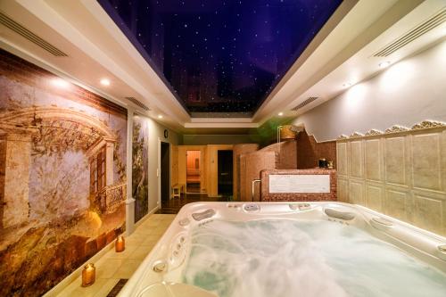 a bath tub in a room with a star ceiling at Na Kamieniu Hotel & Spa in Olesno