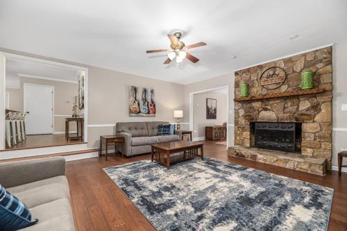a living room with a stone fireplace at Peaceful Kannapolis Lodge in Kannapolis