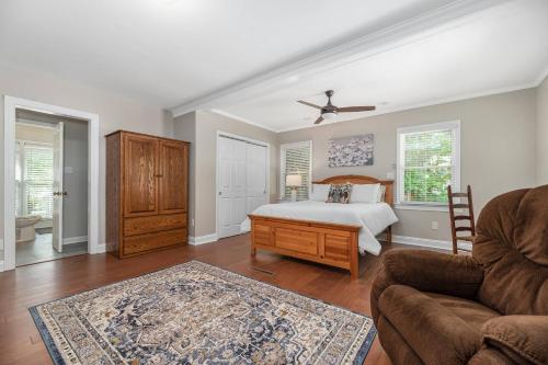 a bedroom with a bed and a couch and a chair at Peaceful Kannapolis Lodge in Kannapolis