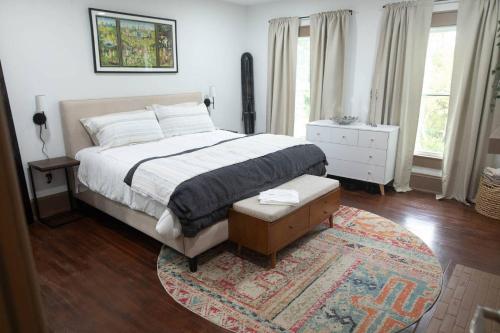 a bedroom with a large bed and a rug at ASecondU Peaceful Retreat in Salisbury