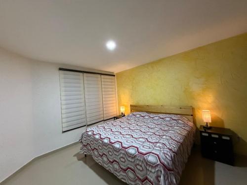 a bedroom with a bed and a window at Modern and Cozy Home in Acayuca