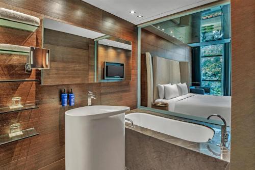 a bathroom with a sink and a mirror at Radisson Blu Atria Bengaluru in Bangalore