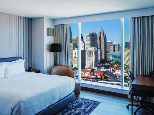 a hotel room with a bed and a large window at Hollywood Casino at Greektown in Detroit