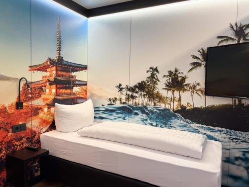 a room with a bed with a picture of a tower at CBS Hotel by WMM Hotels in Cottbus