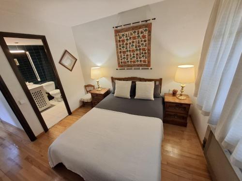 a bedroom with a large bed and a mirror at Llívia Sky Valley in Llivia
