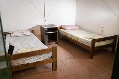 a room with two twin beds and a dresser at Freedom Hostel in Rosario