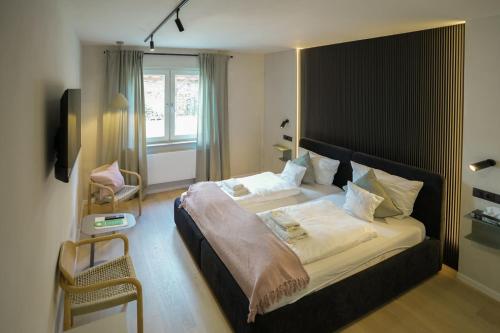a bedroom with a large bed and a window at Boutique Hotel an der Mosel - ehemalig Hotel Kreuter in Koblenz