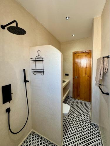 a bathroom with a shower with a toilet and a sink at Dar Youba, Luxe Villa Taghazout in Taghazout