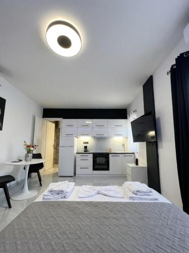 a kitchen with a large bed in a room at Mediterranean Port Suite in Ágios Rókkos