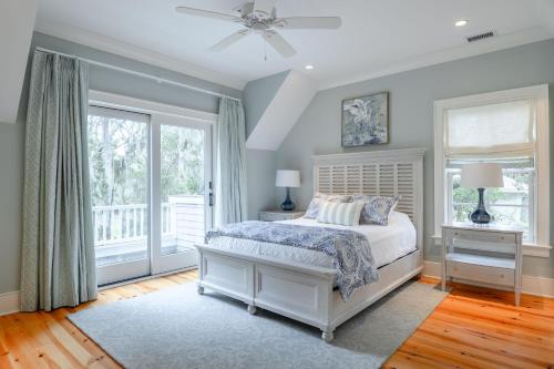 a bedroom with a white bed and a window at 233 Glen Abbey in Kiawah Island
