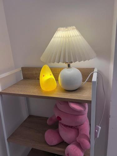 a table with a lamp and a pile of stuffed animals at December homestay studio 002 in Ho Chi Minh City