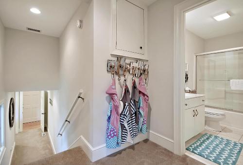 a bathroom with a rack of hanging clothes at 13 Angler Hall in Kiawah Island