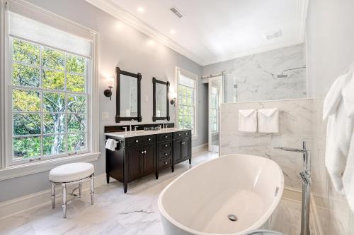 a white bathroom with a tub and a sink at 15 Ocean Course in Kiawah Island